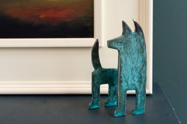 Bronze Dog looking left bronze edges light to dark green patination original Irish art bronze sculpture animals animal sculpture beautiful piece Kilbaha Gallery